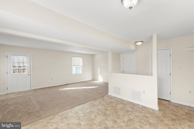 spare room featuring light colored carpet