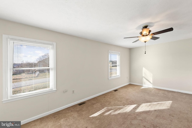 unfurnished room with ceiling fan and light colored carpet