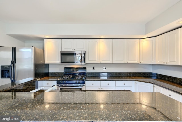 kitchen featuring white cabinets, dark stone countertops, and appliances with stainless steel finishes