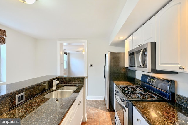 kitchen with white cabinets, dark stone countertops, sink, and appliances with stainless steel finishes