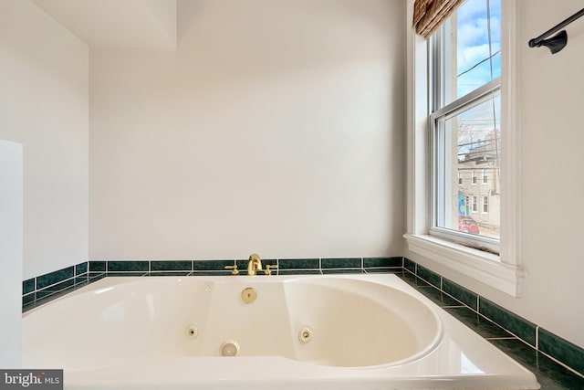 bathroom featuring a wealth of natural light and a bath