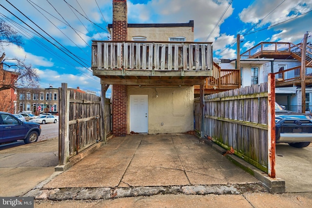 back of house featuring a balcony