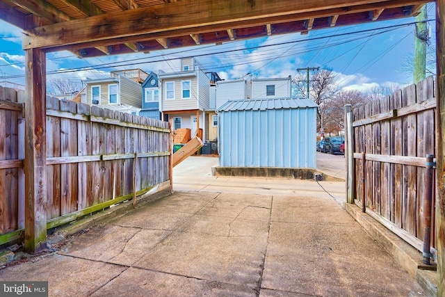 view of patio with a storage unit