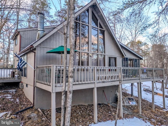 snow covered property featuring a wooden deck