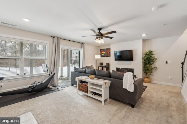 carpeted living room featuring ceiling fan