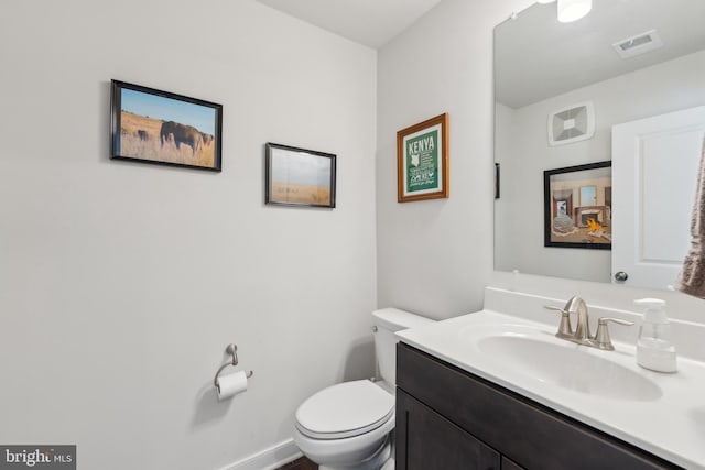 bathroom featuring toilet and vanity