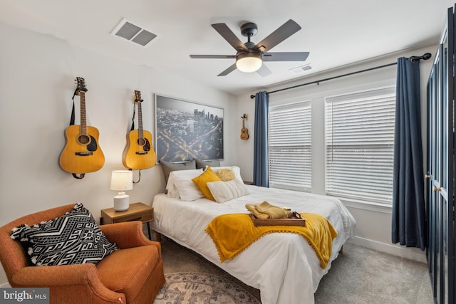 bedroom with ceiling fan, carpet, and multiple windows