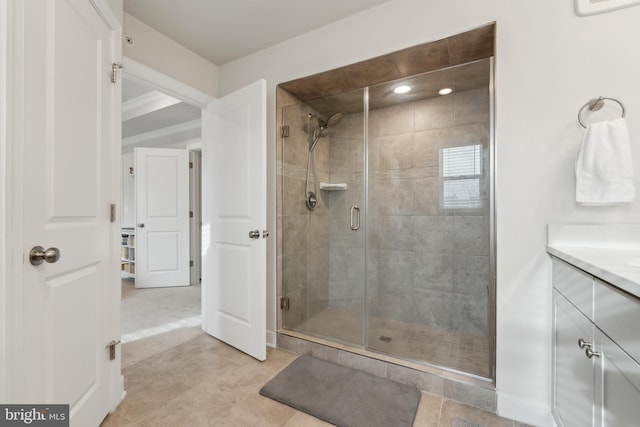 bathroom with vanity, a shower with door, and tile patterned flooring