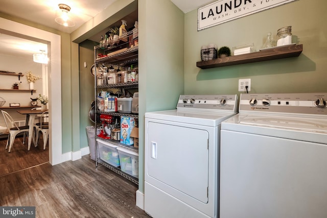 laundry area featuring washer and clothes dryer and dark wood-type flooring