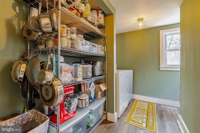 laundry area with hardwood / wood-style flooring and separate washer and dryer