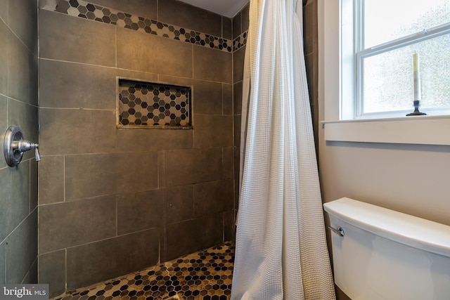 bathroom with toilet and walk in shower