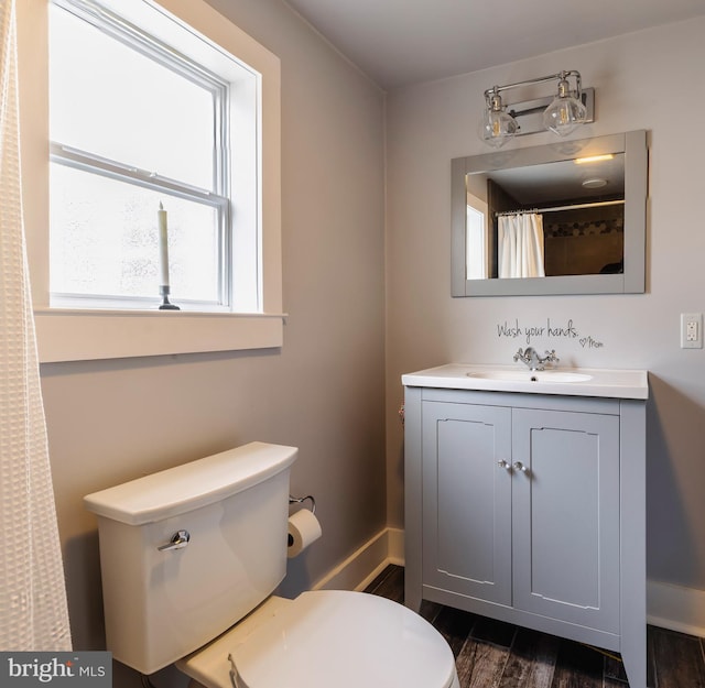 bathroom featuring walk in shower, vanity, and toilet