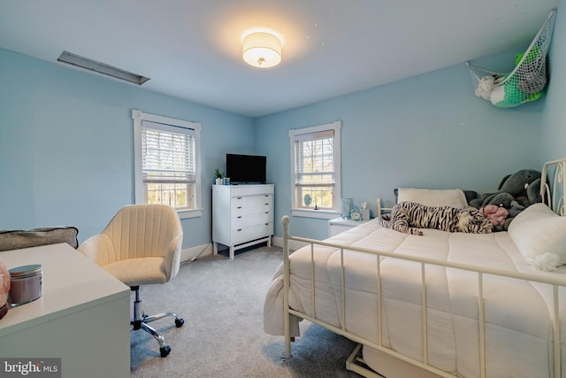 bedroom with carpet flooring and multiple windows