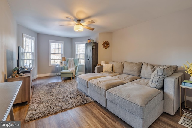 living room with ceiling fan, a healthy amount of sunlight, and dark hardwood / wood-style floors