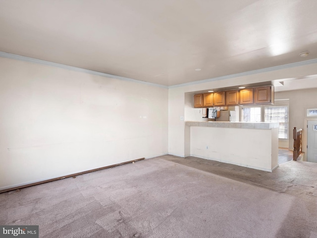 unfurnished living room with light colored carpet and ornamental molding