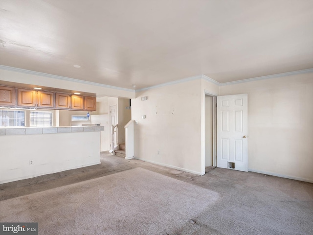 unfurnished living room featuring light carpet, baseboards, and ornamental molding