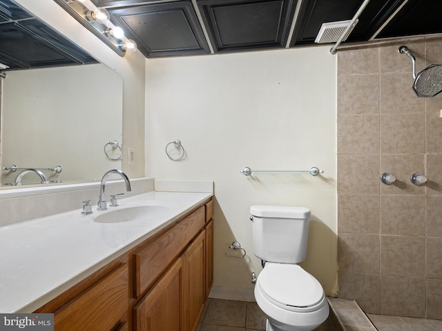 full bath with vanity, visible vents, tiled shower, tile patterned floors, and toilet