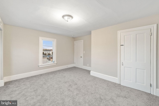 unfurnished bedroom with carpet flooring and baseboards