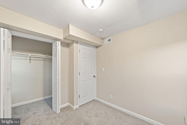 unfurnished bedroom with visible vents, baseboards, a closet, and carpet floors
