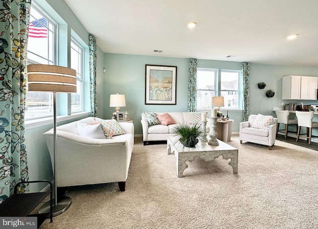 living room with light colored carpet and a wealth of natural light