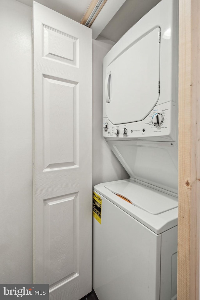 washroom with stacked washer and dryer