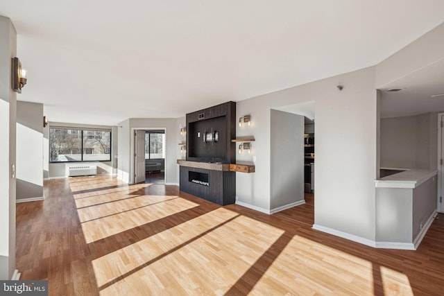 unfurnished living room with hardwood / wood-style flooring