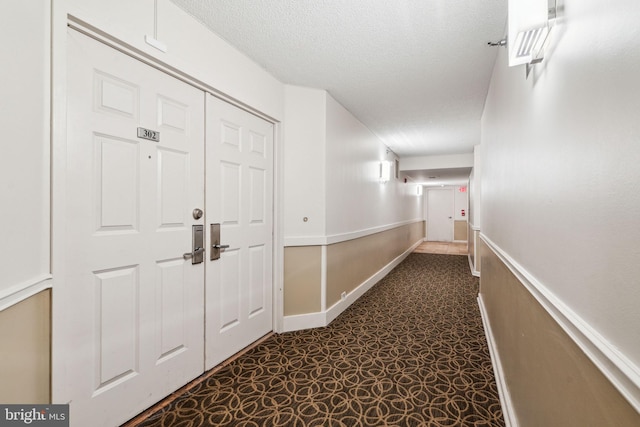 hallway with a textured ceiling