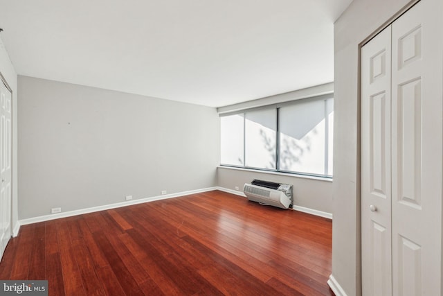 interior space with wood-type flooring and heating unit