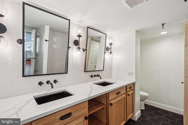 bathroom with tile patterned floors, decorative backsplash, vanity, and toilet