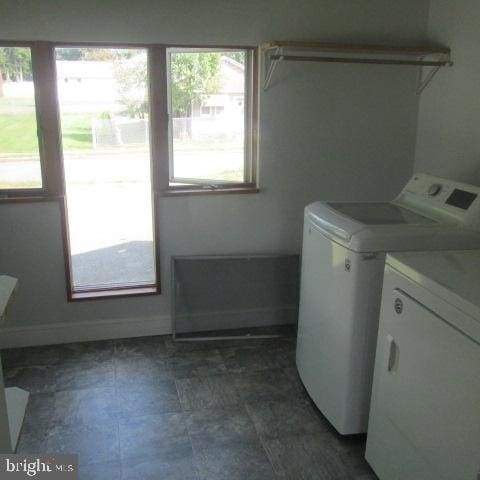 laundry area featuring plenty of natural light and separate washer and dryer