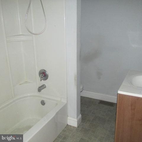 full bathroom with toilet, vanity, and tub / shower combination