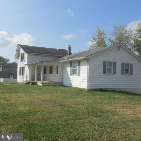 back of house with a lawn