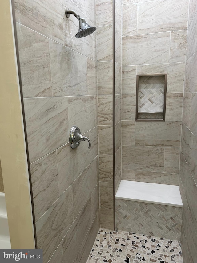 bathroom with a tile shower