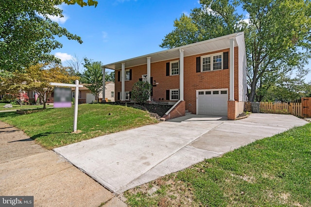 raised ranch with a front yard and a garage