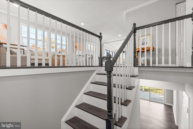 stairway featuring hardwood / wood-style flooring and ornamental molding