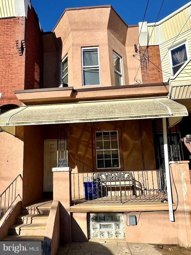 rear view of property with a porch