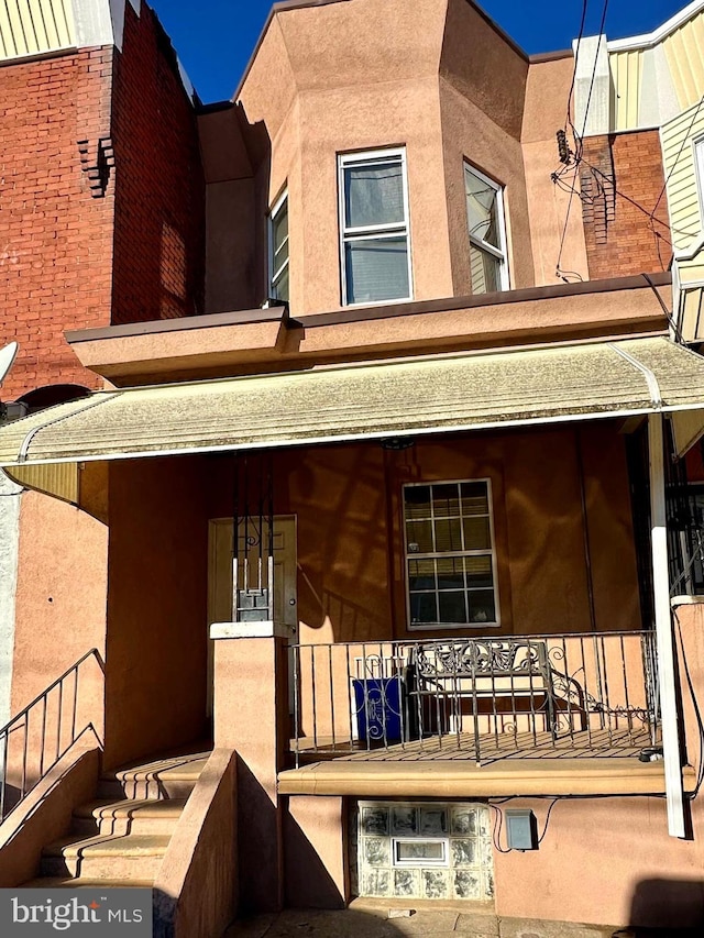 rear view of property with covered porch