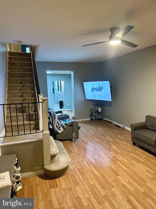 living room with ceiling fan and light hardwood / wood-style floors