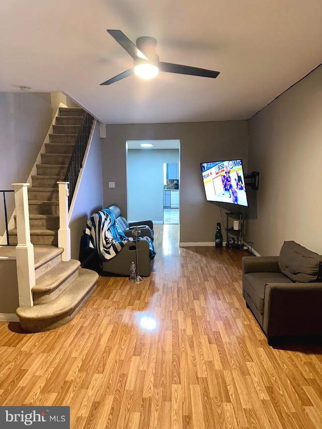 living room with ceiling fan and light wood-type flooring