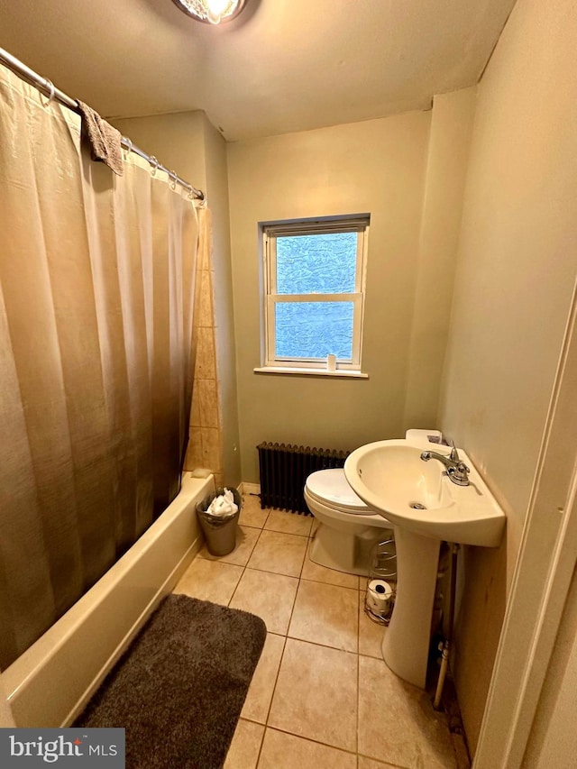 bathroom featuring tile patterned floors, shower / bath combo, toilet, and radiator