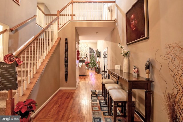 entryway with hardwood / wood-style flooring and a high ceiling