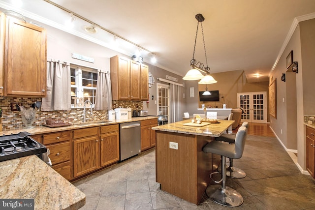 kitchen with french doors, stainless steel dishwasher, a kitchen island, and sink