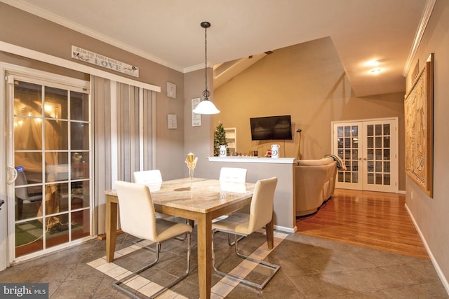 dining space featuring crown molding, french doors, wood-type flooring, and lofted ceiling