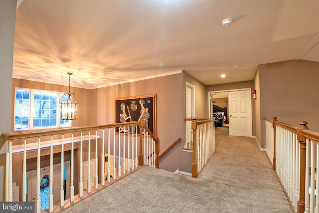 hall featuring light carpet, lofted ceiling, and an inviting chandelier