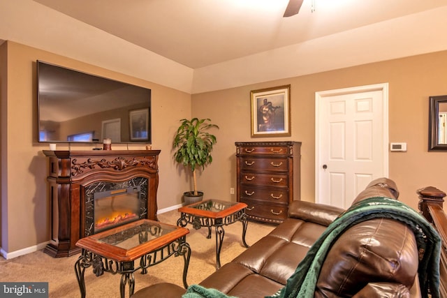 living area featuring light carpet and ceiling fan