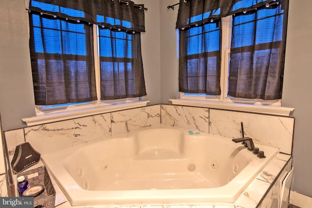 bathroom with a relaxing tiled tub