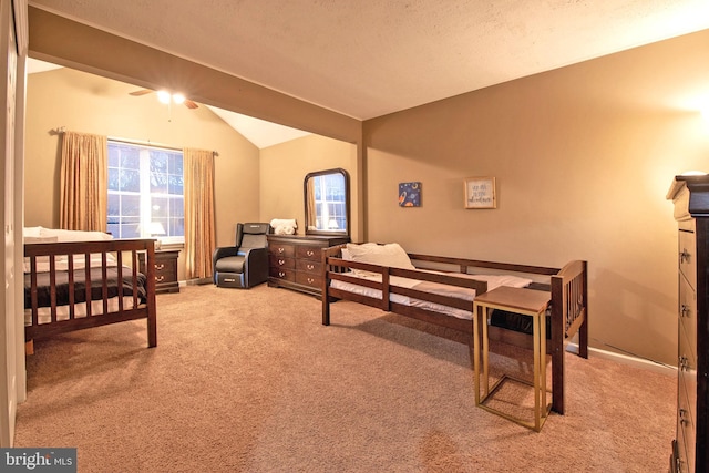 bedroom with lofted ceiling with beams and light colored carpet