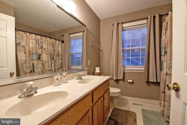 bathroom featuring tile patterned flooring, vanity, and toilet