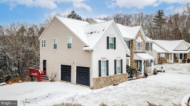 view of snowy exterior featuring a garage