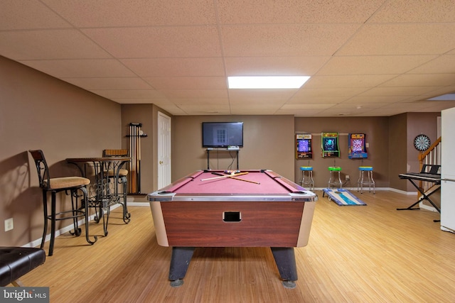 rec room with light hardwood / wood-style flooring, a drop ceiling, and pool table